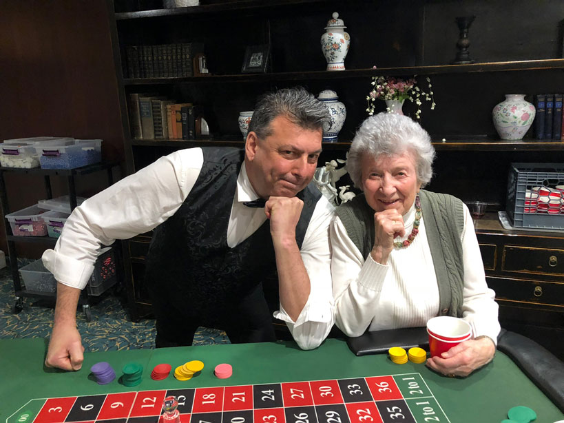 Casino dealer with guests at a MARX entertainment company party